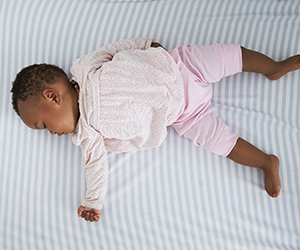African American baby sleeping safely