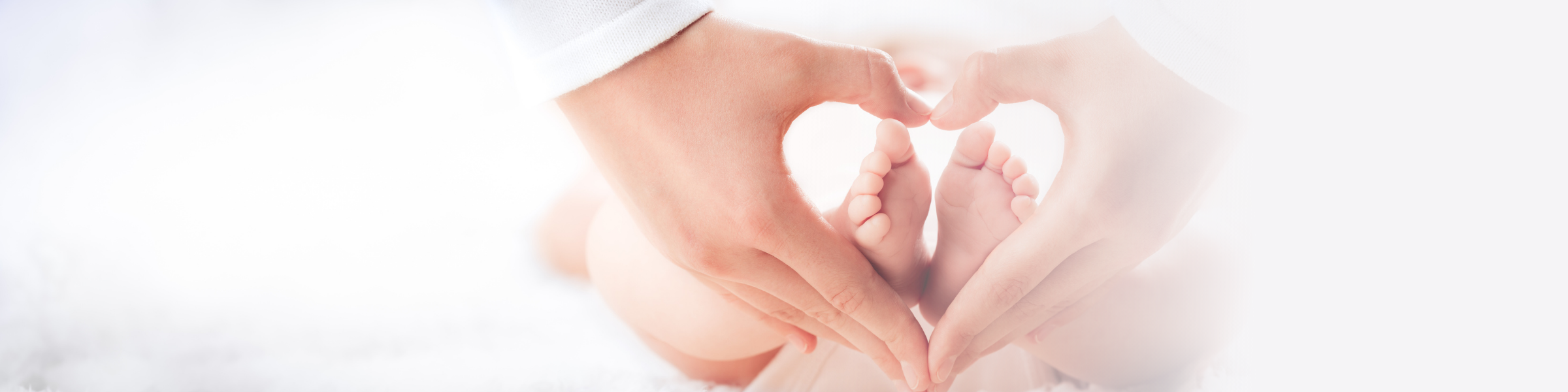 heart hand shape over baby feet