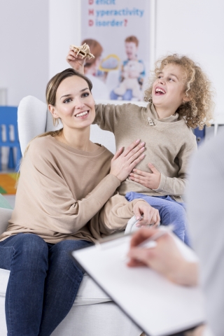 Mother with son with special health need talking to provider
