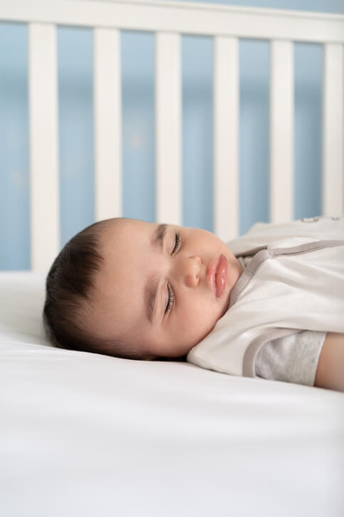 Baby sleeping in a safe crib