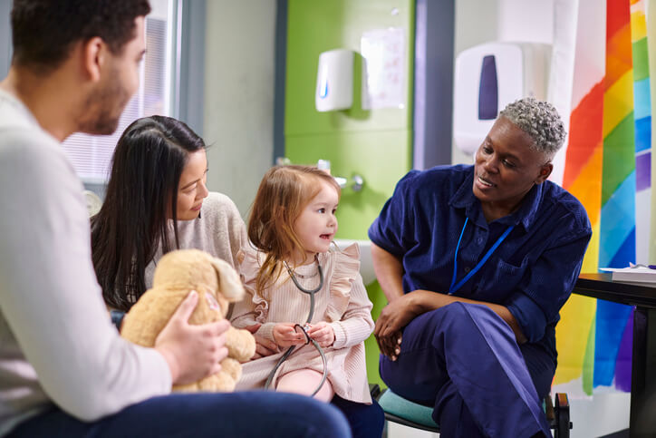 little patient uses the stethoscope on her toy